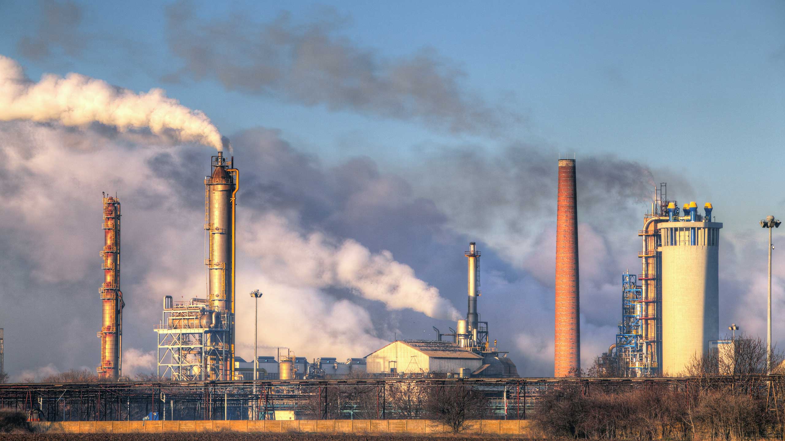 Columns of smoke coming out of factory chimneys.