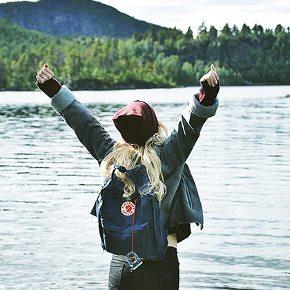 Photo of woman facing a lake