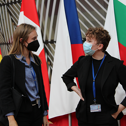 2 young people with mouth masks looking at each other