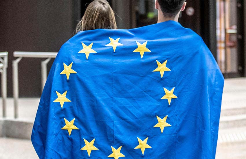 A man and woman wrapped in an EU flag.