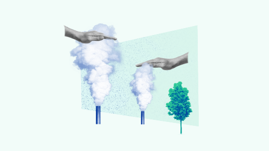 Hands pushing down emissions coming out from factory chimneys.