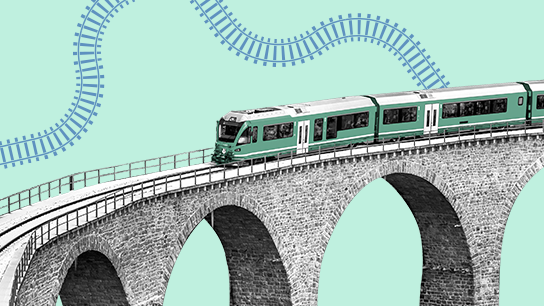 A modern train crossing a high stone viaduct.